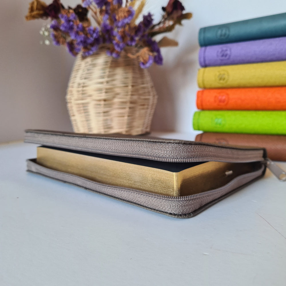 Grey compact size Full Hebrew Bible unzipped laying next to other compact full Hebrew Bibles