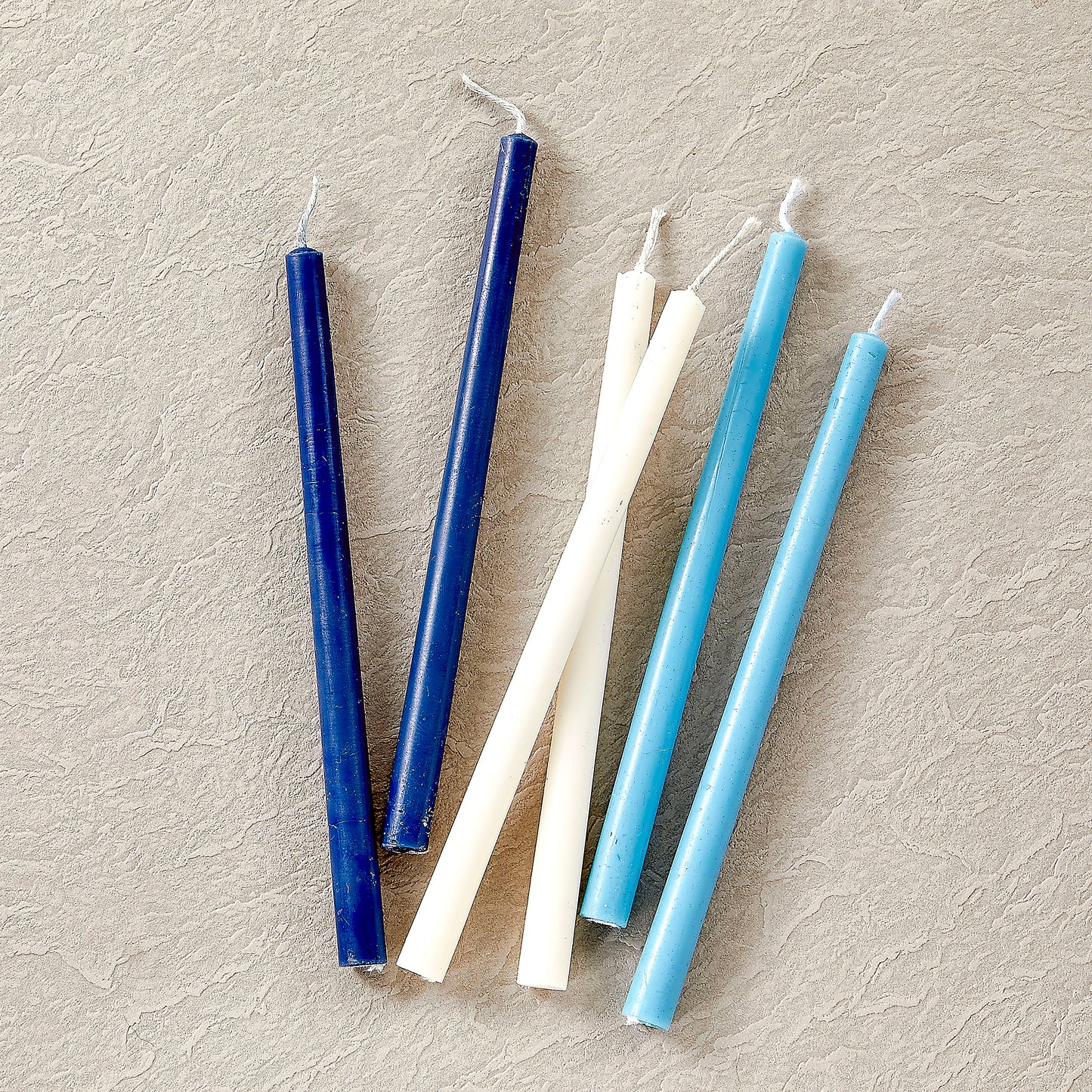 3 pairs of candles, white, light blue, and blue outside of box