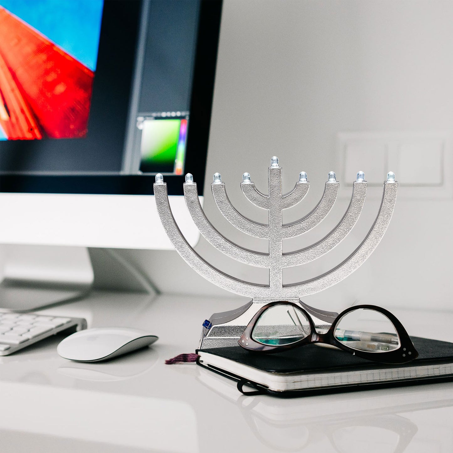 Silver electric menorah on a desk