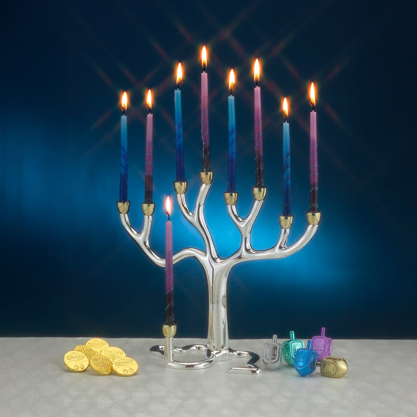 A Large Silver and Gold colored Tree of Life Menorah with lit candles