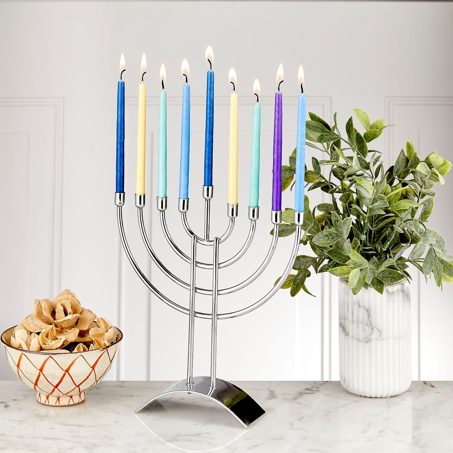 Traditional polished steel menorah with candles lit