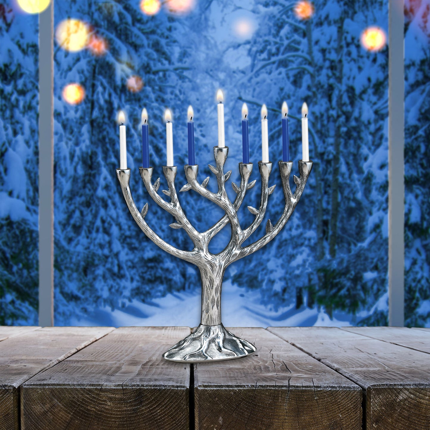 Hand cast aluminum menorah with lit candles displayed in a window