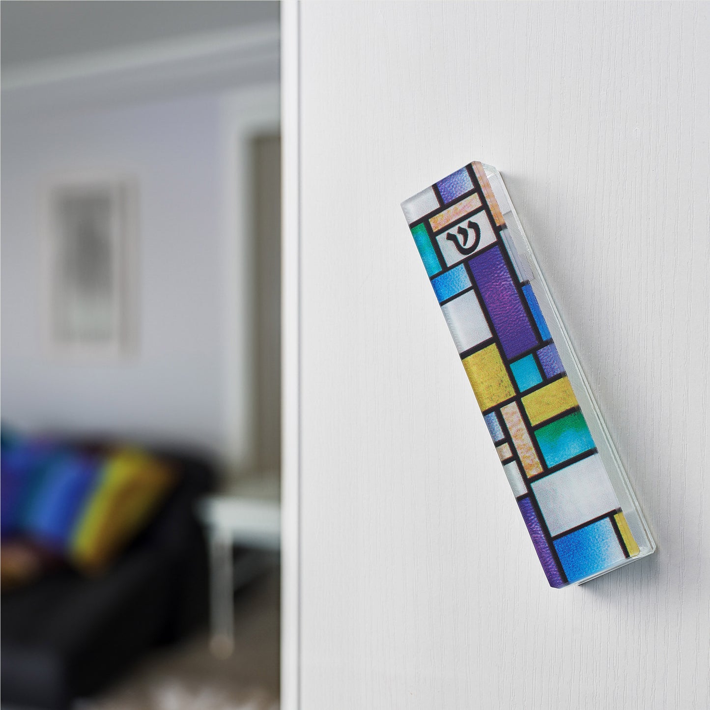 An abstract stained glass design colorful mezuzah hanging on a doorpost