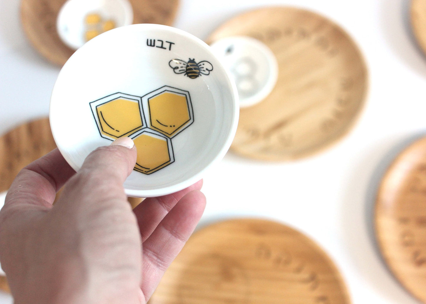 Porcelain bowl with a delicate black and yellow illustration of a bee and honey