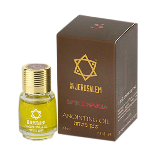 A bottle of spikenard anointing oil with a gold colored cap next to its packaging box. The box has a Star of David symbol.