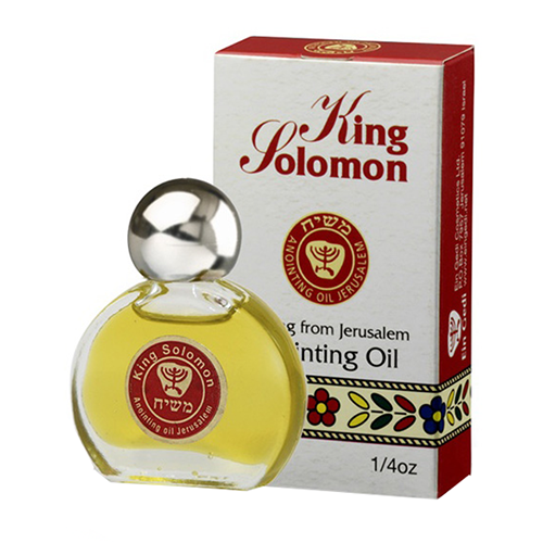 A bottle of King Solomon anointing oil with a red and white label, next to its packaging box.