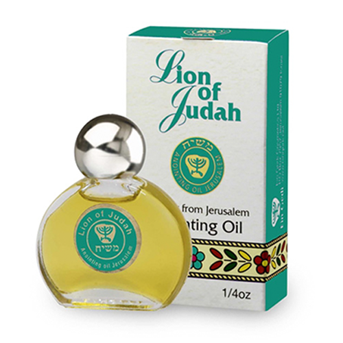 A bottle of Lion of Judah anointing oil with its packaging box. The box is green and white with text and decorative elements, and the bottle is clear with a silver cap.