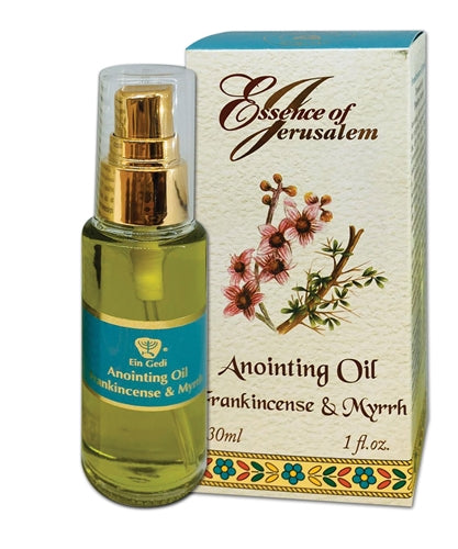 Anointing oil bottle with gold pump and floral packaging labeled 'Essence of Jerusalem' on a white background.