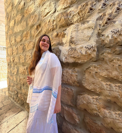 Woman wearing Gabrieli voile blue stripe tallit prayer shawl in Israel