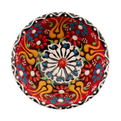 Handmade red ceramic bowl with a multicolored floral design