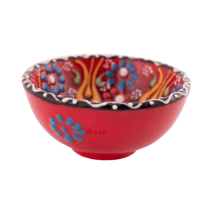 Handmade red ceramic bowl with a multicolored floral design