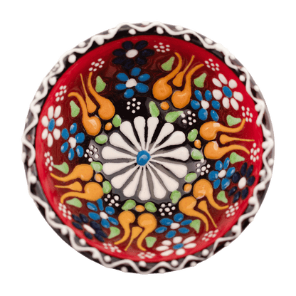 Handmade red ceramic bowl with a multicolored floral design