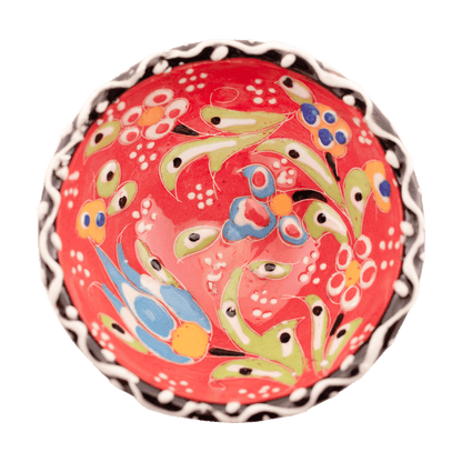 Handmade salmon-colored ceramic bowl with a multicolored floral design