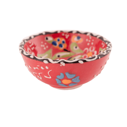 Handmade salmon-colored ceramic bowl with a multicolored floral design