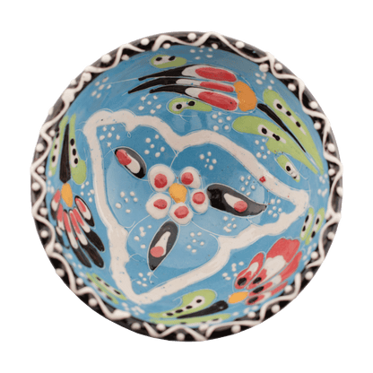 Handmade light blue ceramic bowl with a multicolored floral design