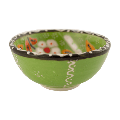 Handmade lime green ceramic bowl with a multicolored floral design