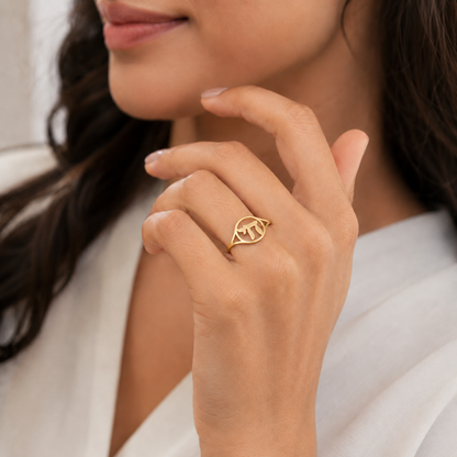 Woman wearing a gold Chai ring with Hebrew symbol design