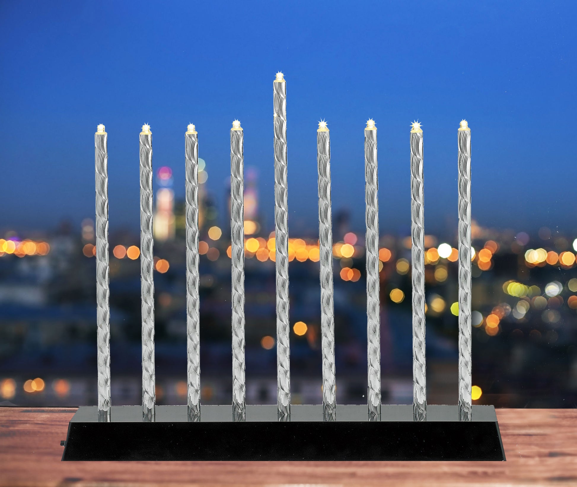 Diamond Cut Aluminum Menorah with LED lights displayed in a window