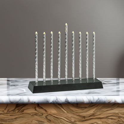 Diamond Cut Aluminum Menorah with LED lights displayed on a countertop