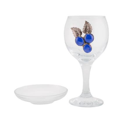 Clear glass Kiddush cup decorated with blue glass beads that resemble a cluster of grapes