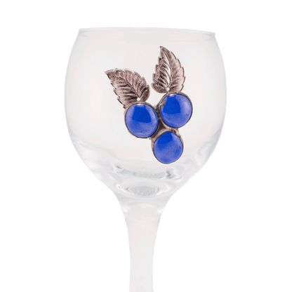 Clear glass Kiddush cup decorated with blue glass beads that resemble a cluster of grapes