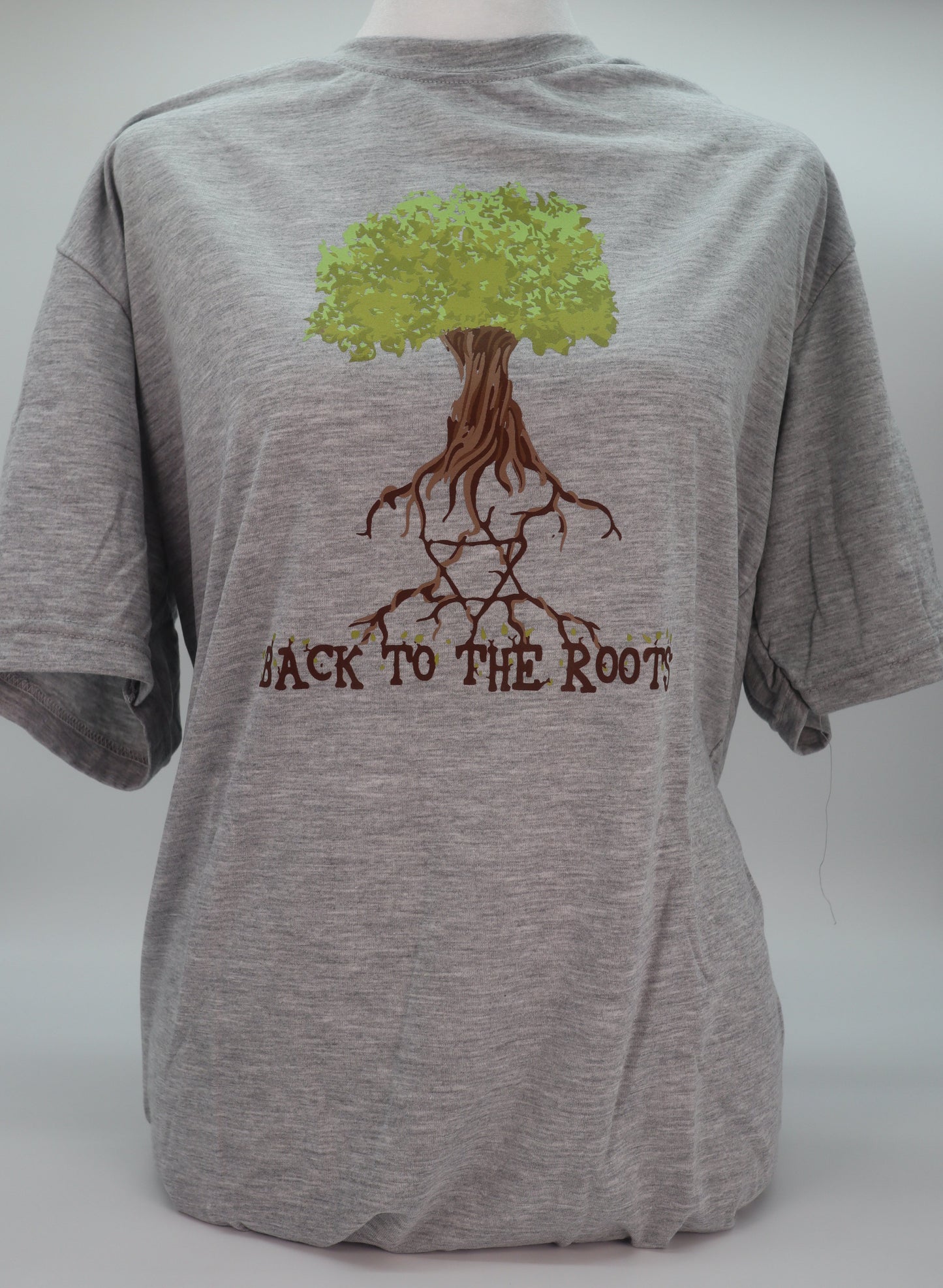 Gray T-shirt with a tree that has the star of David in the roots and the phrase back to the roots underneath