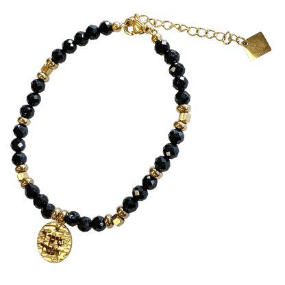 Onyx stone bracelet interspersed with gold-plated beads with a gold-plated charm that says “May God Bless You & Keep You” 