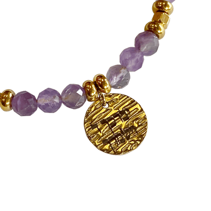 Amethyst stone bracelet interspersed with gold-plated beads with a gold-plated charm that says “May God Bless You & Keep You” 