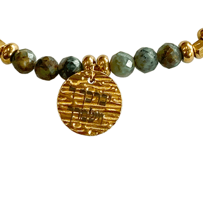 Laborite stone bracelet interspersed with gold-plated beads with a gold-plated charm that says “May God Bless You & Keep You”