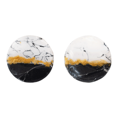 Circular white and black stud earrings made of marbled polymer clay