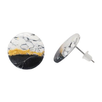 Circular white and black stud earrings made of marbled polymer clay