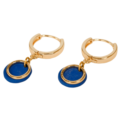 Gold-plated hoop earrings with a cobalt blue polymer clay disc and an open gold circle suspended from the hoop