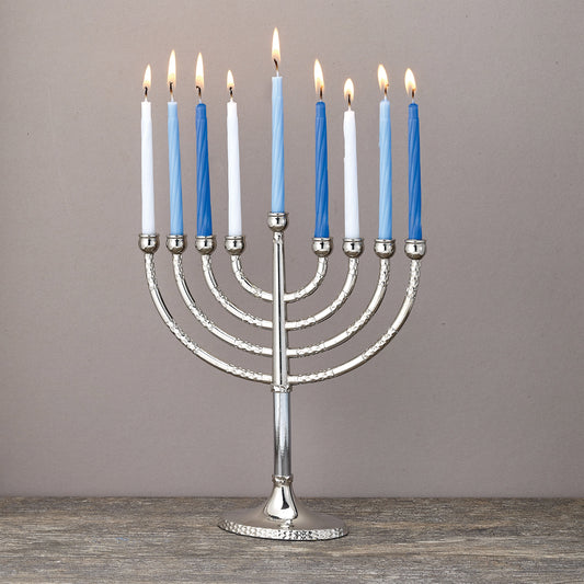 A nickel plated menorah with hammered accents