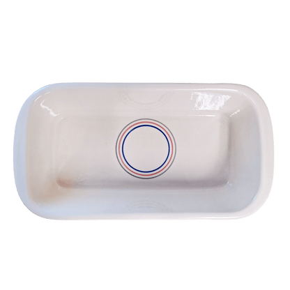 Soft-white rectangular dish made of Lapid stoneware with a multicolored circular design in the bottom of the dish 