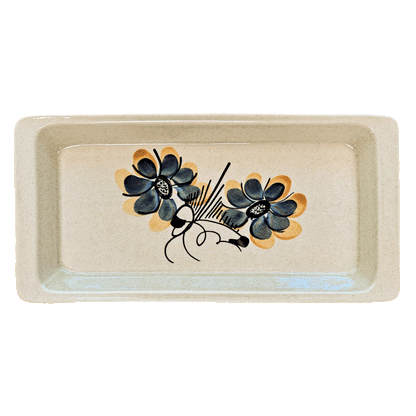 Rectangular speckled cream serving tray made of Lapid stoneware with a dark blue and yellow floral design in the bottom of the dish