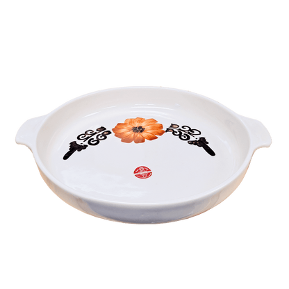 Soft-white circular dish made of Lapid stoneware with an orange and brown floral design in the bottom of the dish