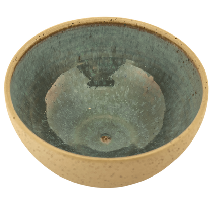 Handcrafted ceramic deep teal and sand-colored bowl