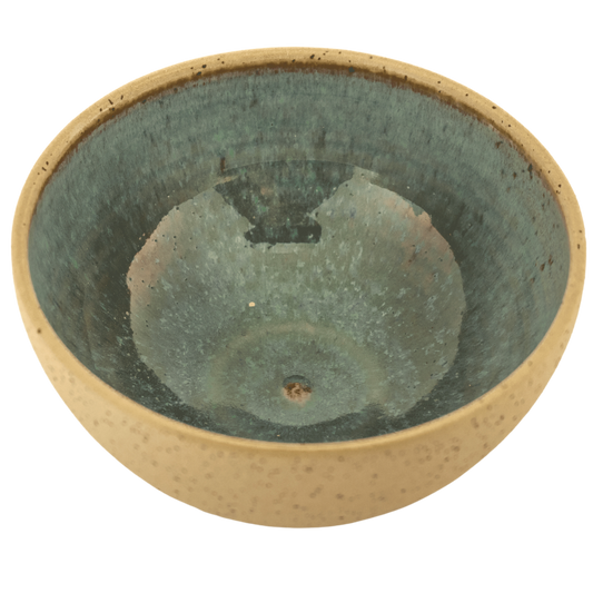 Handcrafted ceramic deep teal and sand-colored bowl