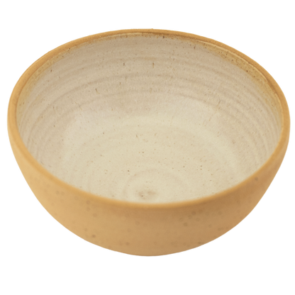 Handcrafted ceramic seafoam green and sand-colored bowl