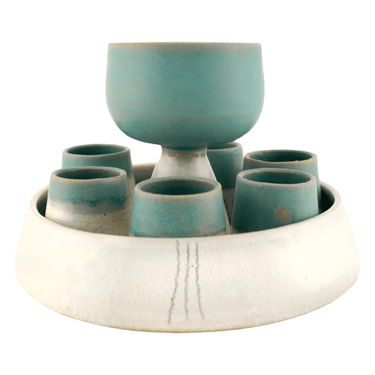 White and teal handcrafted ceramic communion set with a wine vessel, six cups, and a serving dish