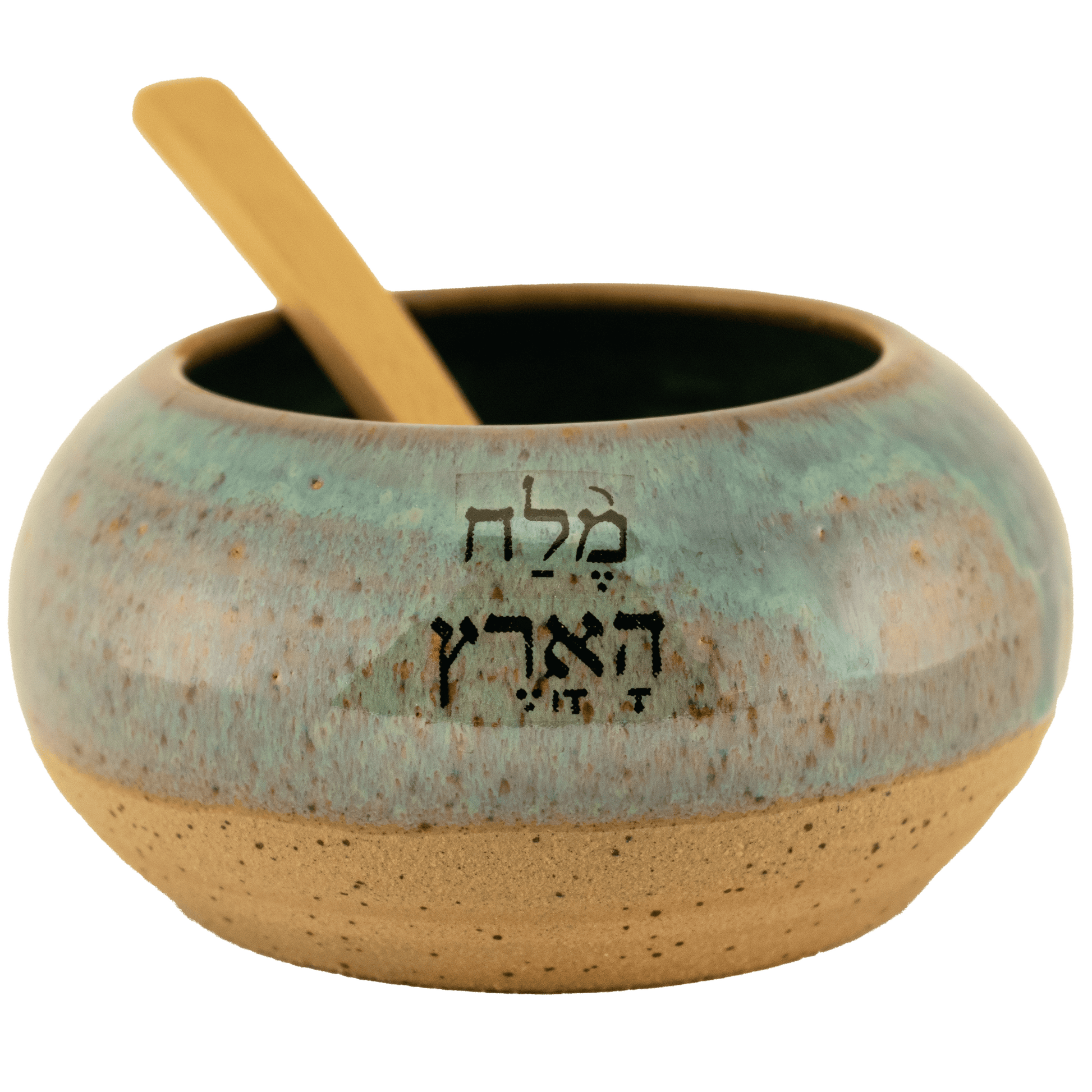 Deep teal ceramic salt bowl that says "salt of the earth" in English and Hebrew with a wooden spoon