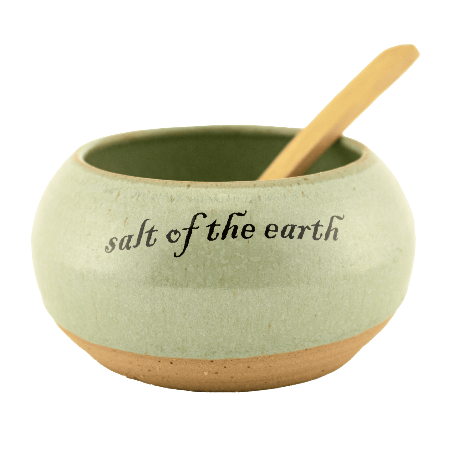 Seafoam green ceramic salt bowl that  says "salt of the earth" in English and Hebrew with a wooden spoon