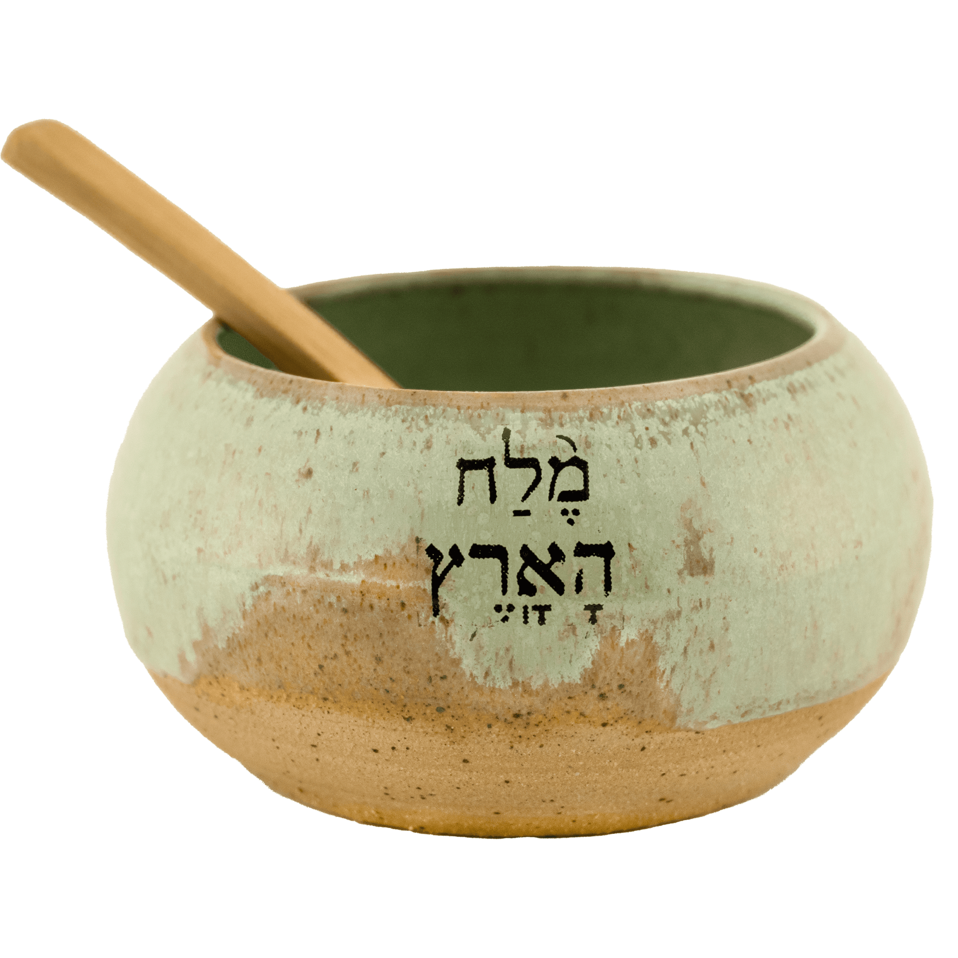 Seafoam green ceramic salt bowl that  says "salt of the earth" in English and Hebrew with a wooden spoon