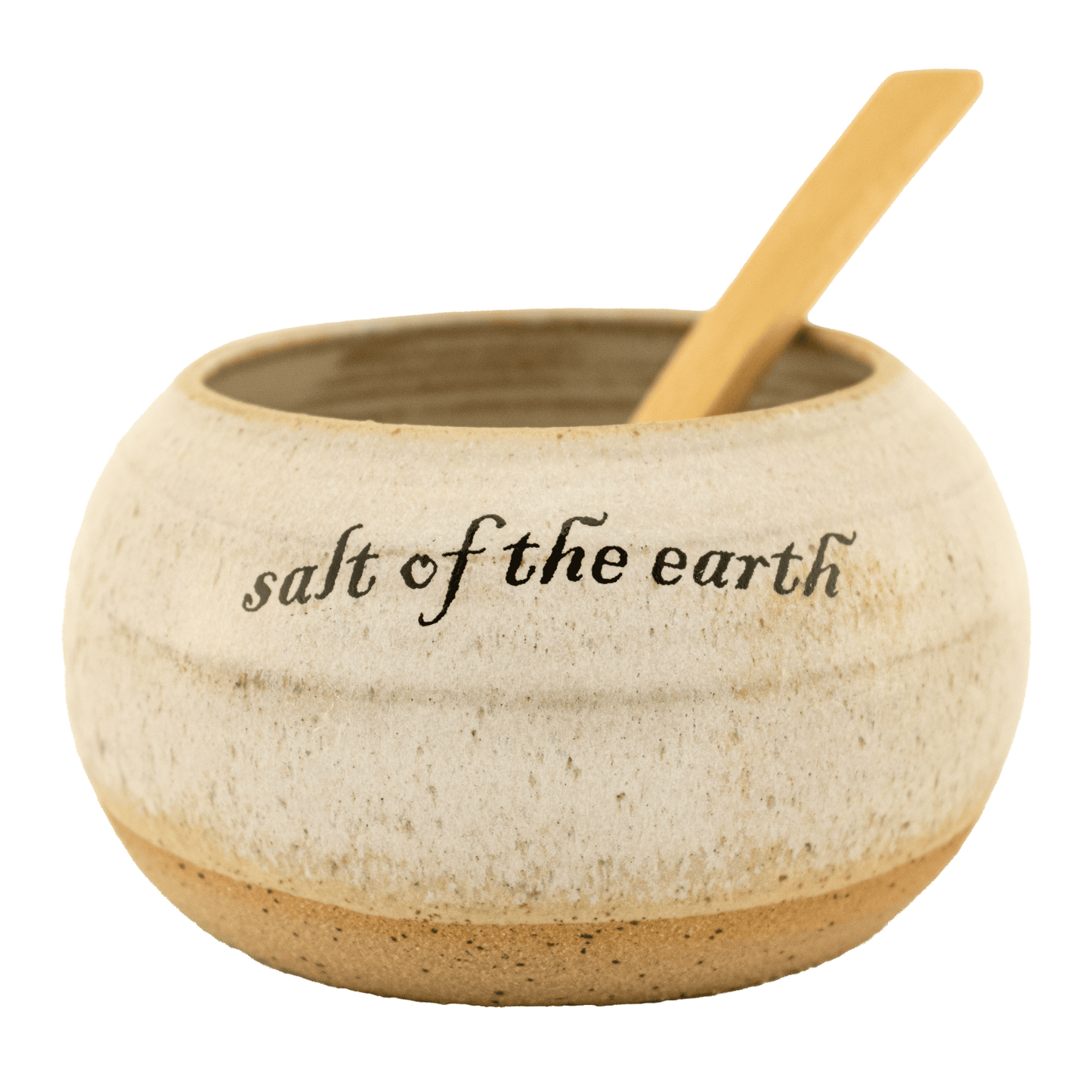 Pearl-colored ceramic salt bowl that says "salt of the earth" in English and Hebrew with a wooden spoon