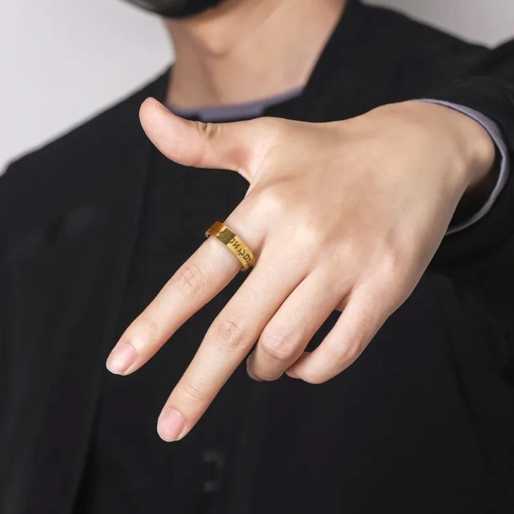 Gold Hebrew Shema inscription ring worn on a man’s hand
