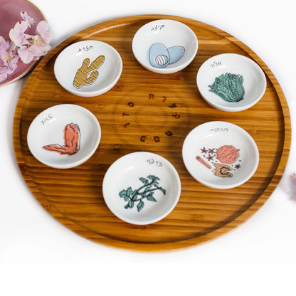 Closeup of Bamboo Passover Seder plate with porcelain bowls featuring colorful illustrations 