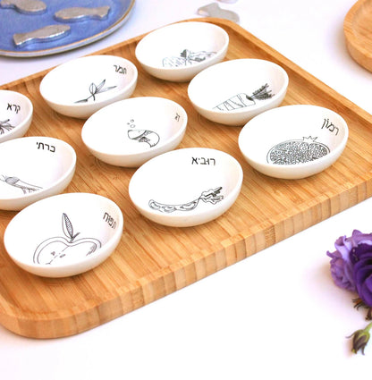 Modern black and white bamboo Rosh Hashanah set with 9 porcelain bowls shown from the side