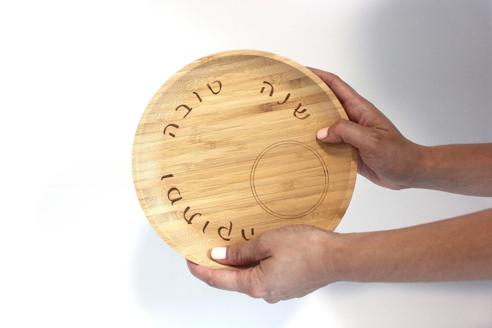 Hands holding bamboo tray