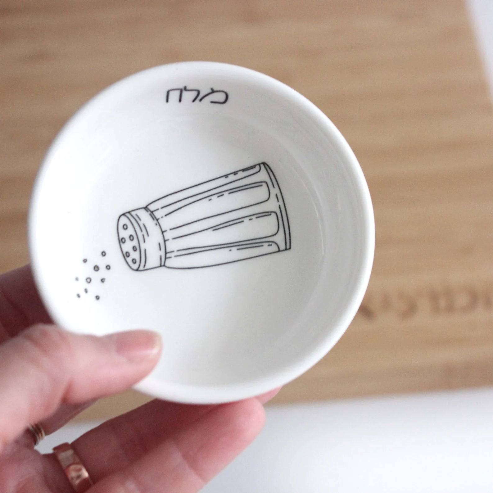 Porcelain bowl featuring an illustration of a black and white salt shaker