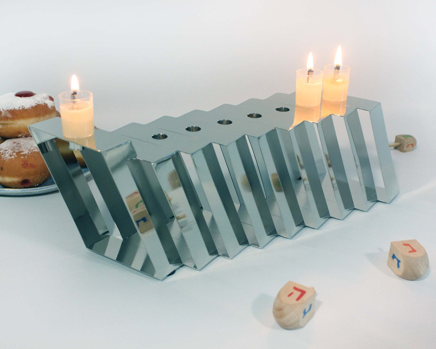 Silver Hanukkiah with three lit candles